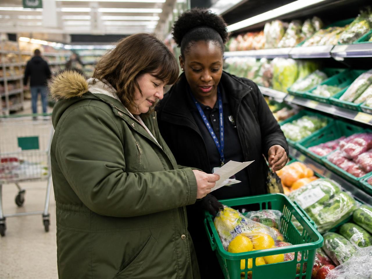A support worker and the person she supports preparing a meal together in a home kitchen